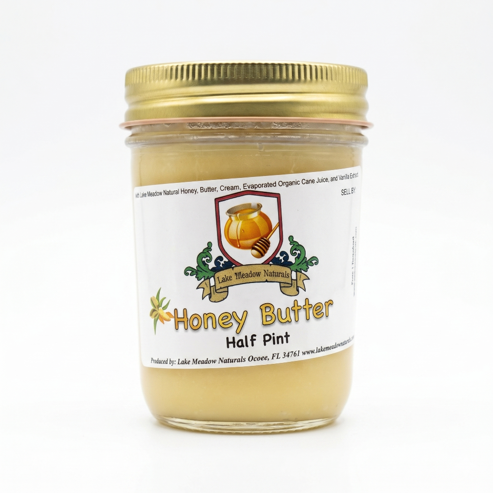 Jar of honey butter with a gold lid on a white background