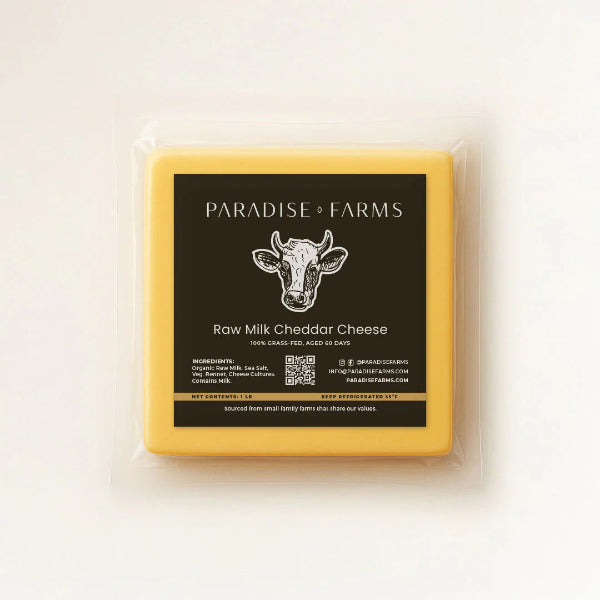 Box of Paradise Farms raw milk cheddar cheese on a white background